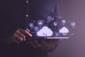 Man using digital tablet with holographic cloud computing icons, representing data storage, online communication Royalty Free Stock Photo