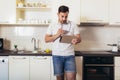 Man using digital tablet in kitchen at home Royalty Free Stock Photo