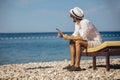 Man using digital tablet at sea beach Royalty Free Stock Photo