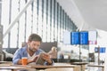 Man using digital tablet while waiting for his flight in airport Royalty Free Stock Photo