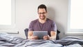 Man Using Digital Tablet Watching Movie Online Sitting In Bedroom Royalty Free Stock Photo