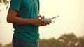 Man using drone RC remote at sunset Royalty Free Stock Photo