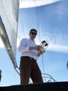 Man using drone when sailing on luxury sail yacht