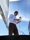Man using drone when sailing on luxury sail yacht