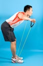 Man using elastic exercise tubing in strengthening