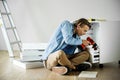 A man using electronic drill install cabinet home repair