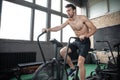 Man using exercise bike at the gym. Fitness male using air bike for cardio workout at Functional training gym Royalty Free Stock Photo