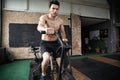 Man using exercise bike at the gym. Fitness male using air bike for cardio workout at Functional training gym