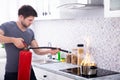 Man Extinguishing Burning Cooking Pot Royalty Free Stock Photo