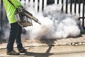 Man using fogger machine to control dangerous from mosquitoes Royalty Free Stock Photo