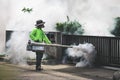 Man using fogger machine to control dangerous from mosquitoes Royalty Free Stock Photo