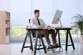 Man using footrest while working on computer