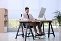 Man using footrest while working on computer Royalty Free Stock Photo