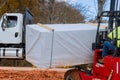 Man using a forklift working on unloading the construction parts of the building materials Royalty Free Stock Photo