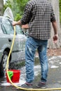 Man using garden hose for cleaning Royalty Free Stock Photo