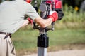 Man using gasoline hand held pole ramming tool outdoors on construction site. Royalty Free Stock Photo