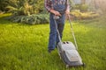 Man using a grass cutter to trim his lawn