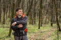 Man using hiking sticks poles outdoors in woods.