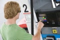 Man Using His Debit Card To Pay For Gasoline At Pump