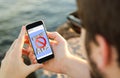 Man using his mobile phone on the coast with ads blocker