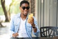 Man using his mobile phone at coffee shop. Royalty Free Stock Photo