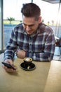 Man using his mobile phone in the coffee shop Royalty Free Stock Photo