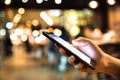 Man using his Mobile Phone in the pub or  restaurant. Royalty Free Stock Photo