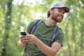 man using smartphone in forest Royalty Free Stock Photo