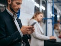 man using his smartphone while sitting in the train subway. Royalty Free Stock Photo