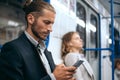 Man using his smartphone while sitting in the train subway. Royalty Free Stock Photo