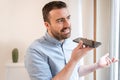 Man using home assistant bluetooth speaker Royalty Free Stock Photo