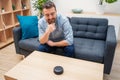 Man using home assistant bluetooth speaker Royalty Free Stock Photo