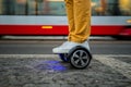 Man using hoverboard against the background of the tram Royalty Free Stock Photo