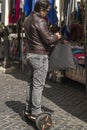 Man using hoverboard at fair in field of flowers