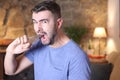 Man using industrial pliers to remove tooth