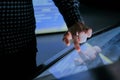 Man using interactive touchscreen display at modern history museum