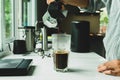 Man using Italian classic Moka coffee pot pouring, coffee maker with equipment tool brewing marble bar. Close up