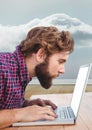 Man using laptop against grey background Royalty Free Stock Photo