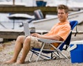 Man using laptop on beach Royalty Free Stock Photo