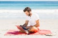 Man using laptop on beach Royalty Free Stock Photo