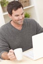 Man Using Laptop Computer At Home