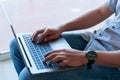 Man using laptop computer while sitting in living room Royalty Free Stock Photo