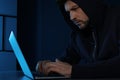 Man using laptop in room. Criminal offence Royalty Free Stock Photo