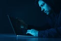 Man using laptop in dark room Royalty Free Stock Photo