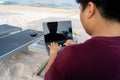 Man using laptop with glass of wine on white sand beach Royalty Free Stock Photo