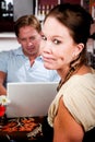 Man using laptop ignoring his date in coffee house Royalty Free Stock Photo