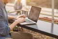 Man using a laptop on an outdoor table Royalty Free Stock Photo