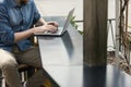 Man using a laptop on an outdoor table Royalty Free Stock Photo