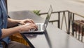 Man using a laptop on an outdoor table Royalty Free Stock Photo