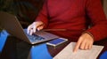 Man using laptop and pointing to a pressed sheet